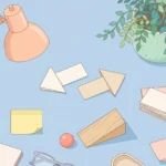 Pastel desk scene with paper arrows, a ball on a ramp, blank cards and sticky notes on a powder blue background