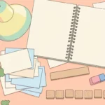 Pastel desk scene with blank wooden tiles, index cards, pencils and a notebook on a mint green background.