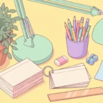 Pastel desk scene with blank index cards on a ring, a pencil cup, an eraser and a plant on a butter yellow background.