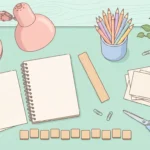 Pastel desk scene with blank cards, wooden tiles, pencils and a notebook on a peach background.